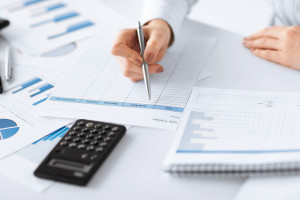 picture of woman hand with calculator and papers